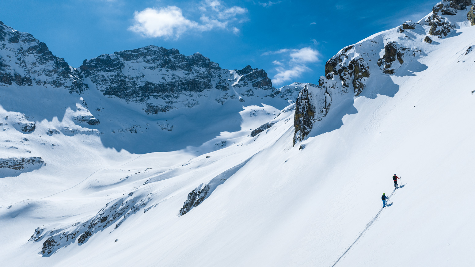 Giray Dadali and Turkish ski guide Ercan Selim Kolbakır make their way up to ski the trophy line of our trip. The day before, we were met with challenging avalanche conditions, but after recon and a snow pit analysis, our guide felt good about just him and Giray venturing higher, leaving the support crew with their snowmobiles in safer zones.