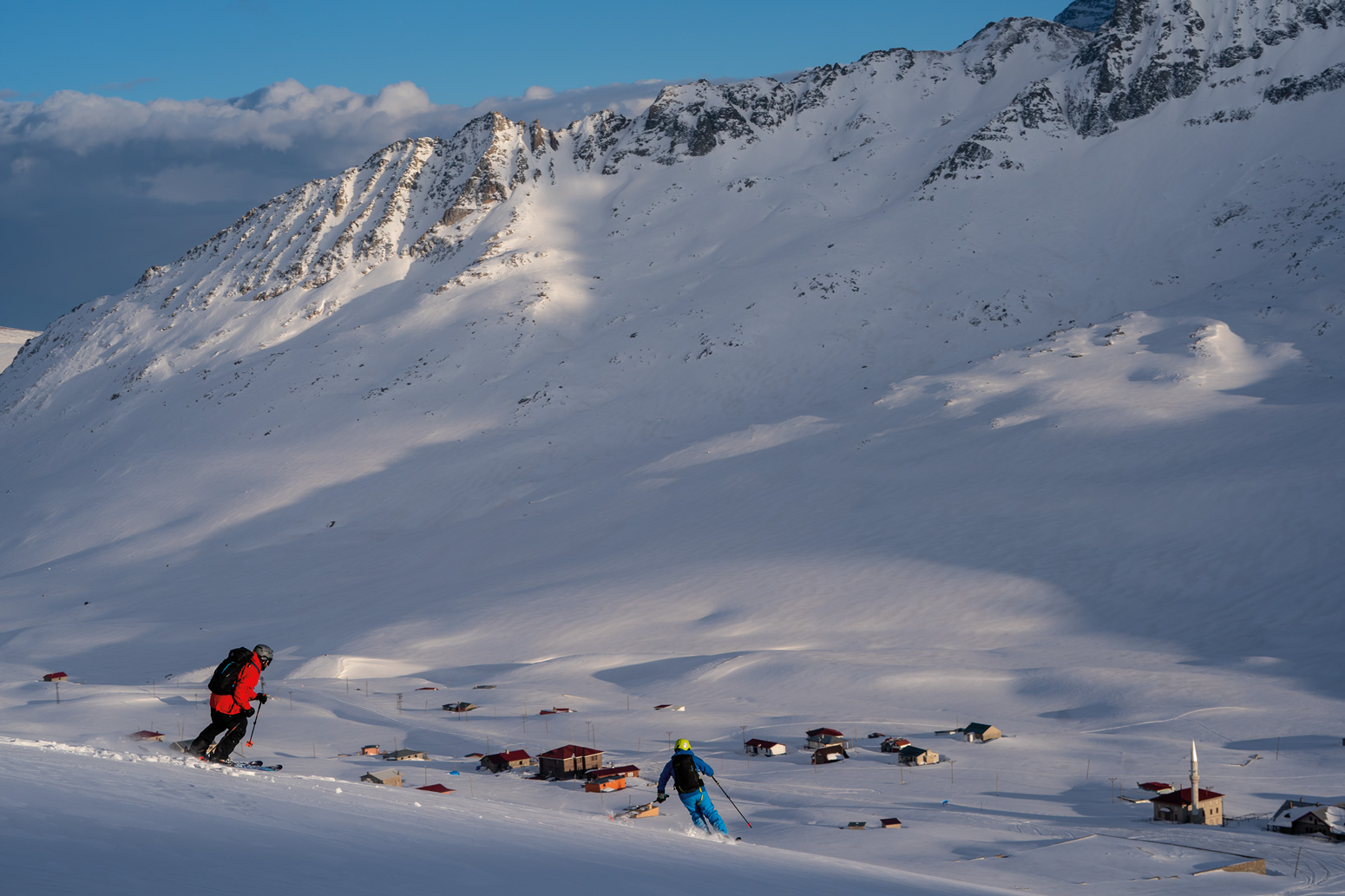 Ercan and Giray finishing skiing back to the Ovit 2640 Hotel at the end of the day. The view is typical of many mountain villages, but the mosque in the bottom of the frame adds a bit of cultural context.
